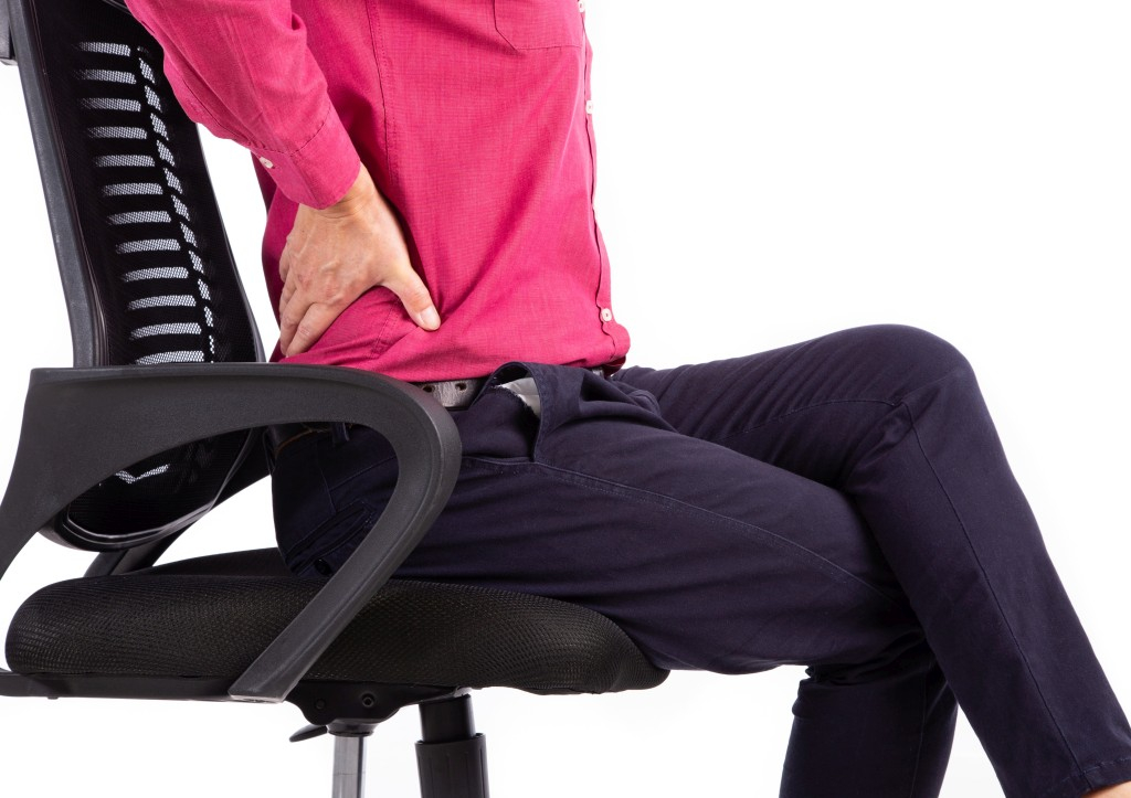 Image showing man with back pain in an office chair